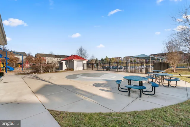 a view of a swimming pool with a bench and lawn chairs