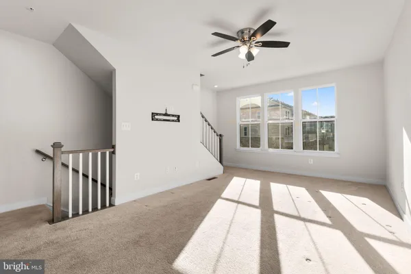 a view of an empty room with a kitchen
