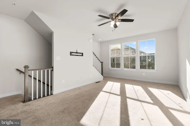 a view of an empty room with a kitchen