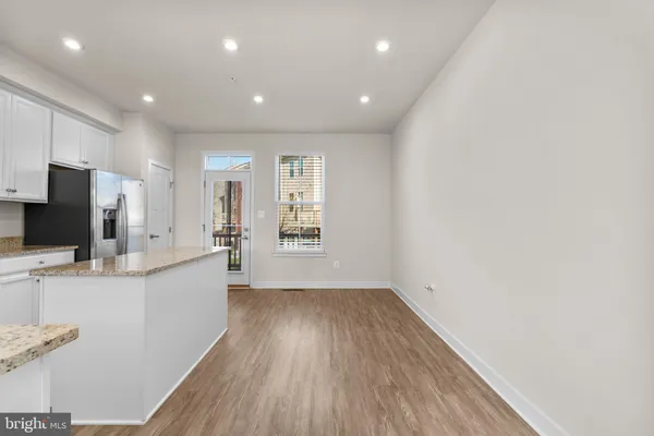 a kitchen with a refrigerator and a stove top oven