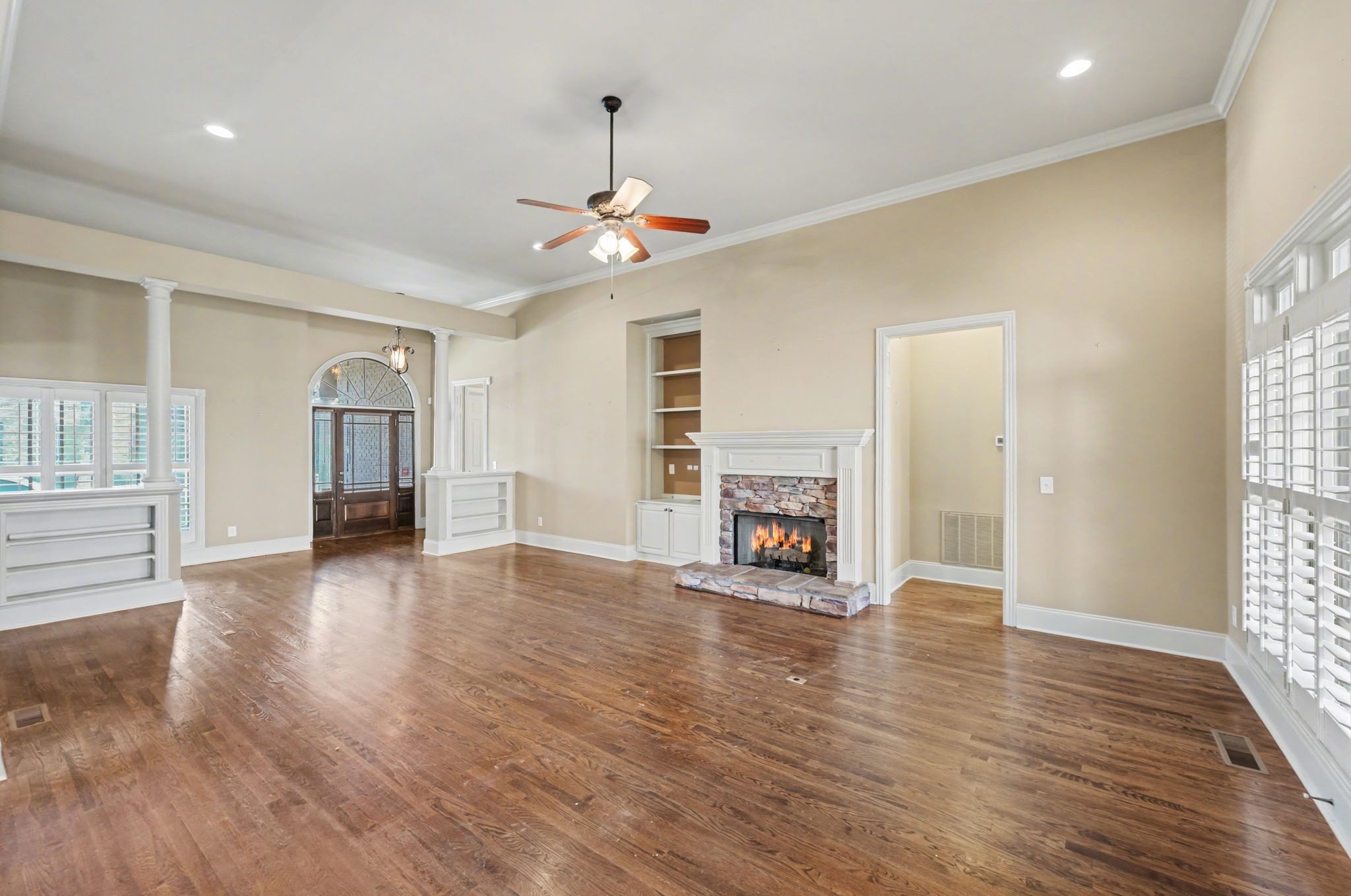 405 Luna Court Franklin, TN 37064 - Photo 15 of 57 an empty room with wooden floor fireplace and windows
