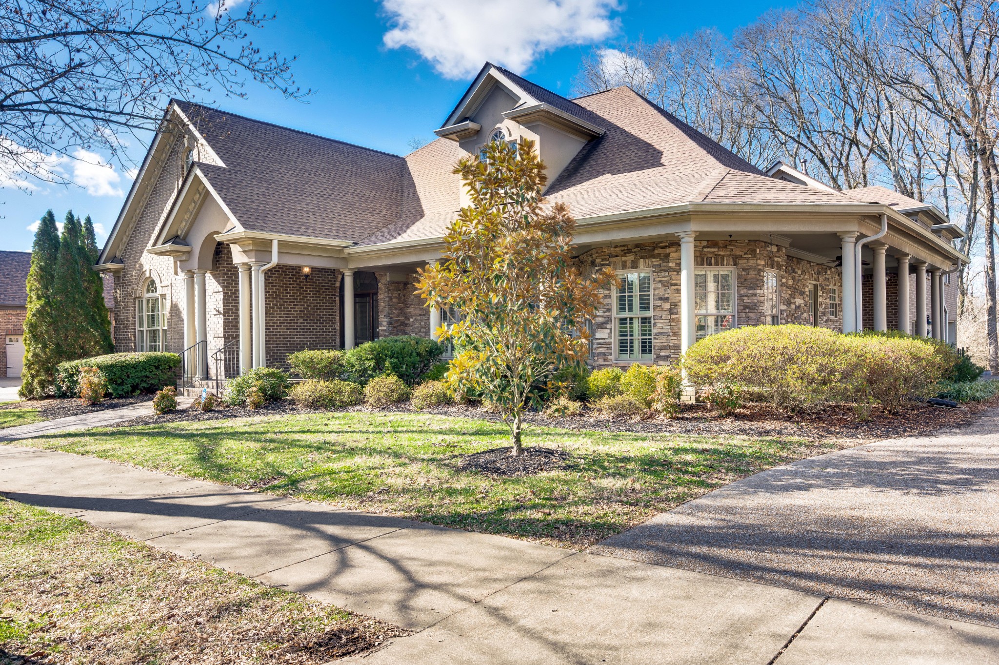 405 Luna Court Franklin, TN 37064 - Photo 2 of 57 a front view of a house with a garden
