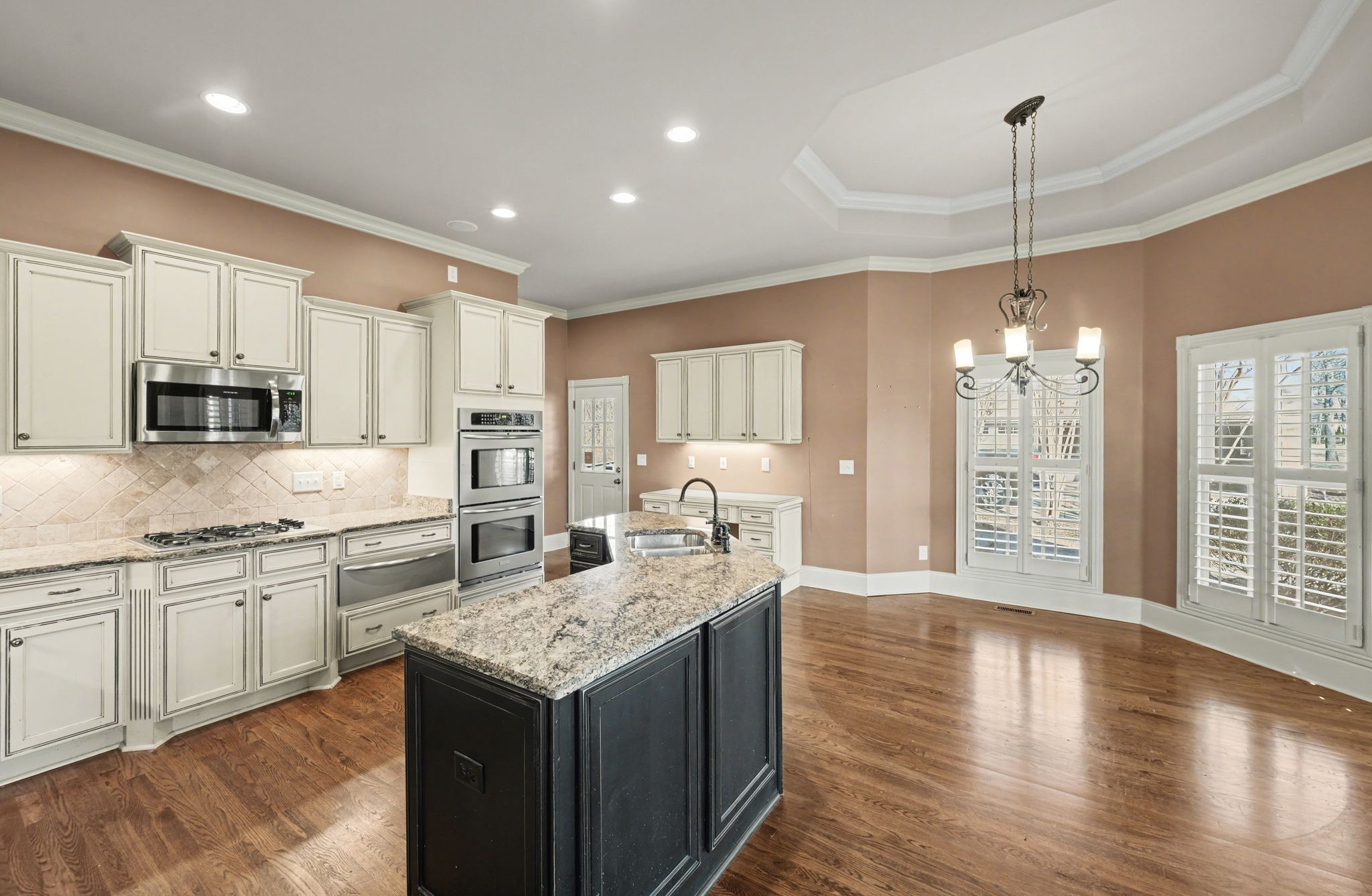405 Luna Court Franklin, TN 37064 - Photo 22 of 57 a kitchen with stainless steel appliances granite countertop a sink stove and wooden floor