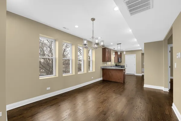 a open kitchen with window and wooden floor