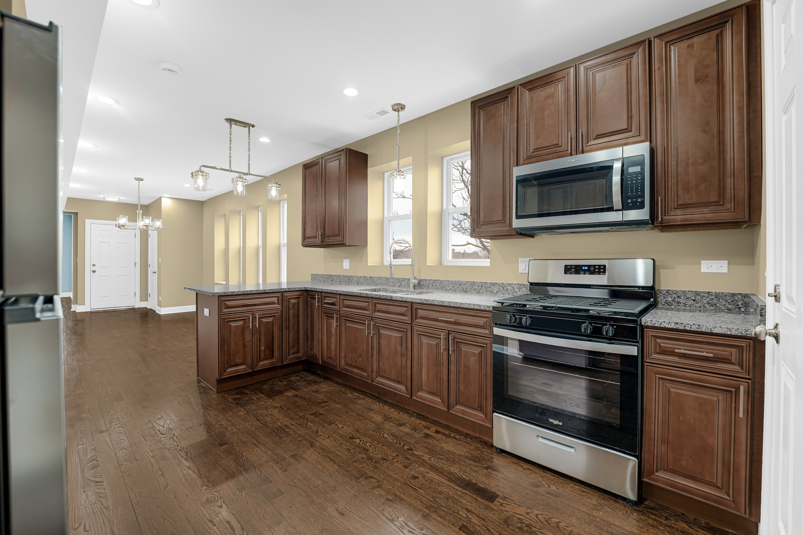 7316 South Rockwell Street, Unit 2 Chicago, IL 60629 - Photo 7 of 9 a kitchen with stainless steel appliances granite countertop a stove a sink and a microwave