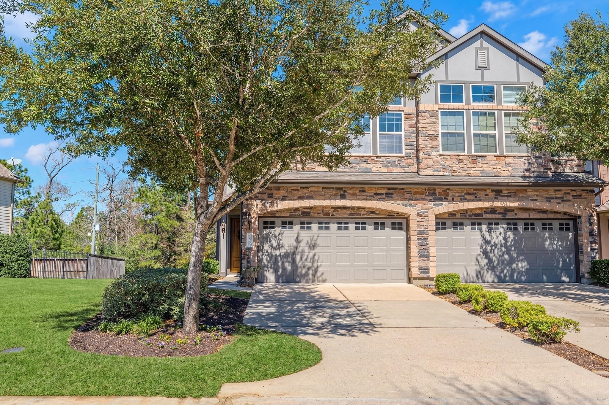 58 Aventura Place Spring, TX 77389 - Photo 2 of 23 a front view of a house with garden