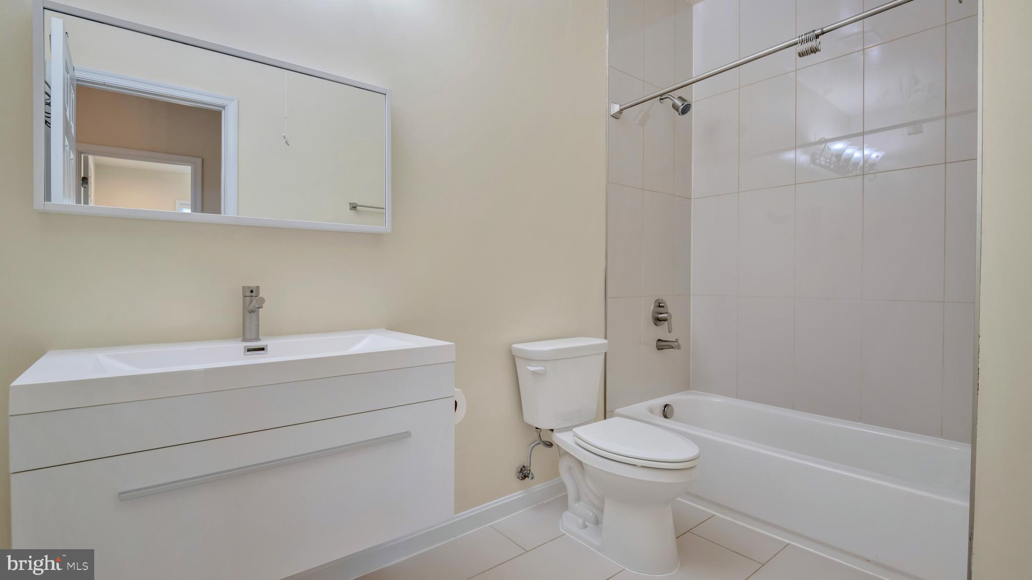 1337 Maple View Place Southeast Washington, DC 20020 - Photo 20 of 27 a bathroom with a sink a toilet and shower