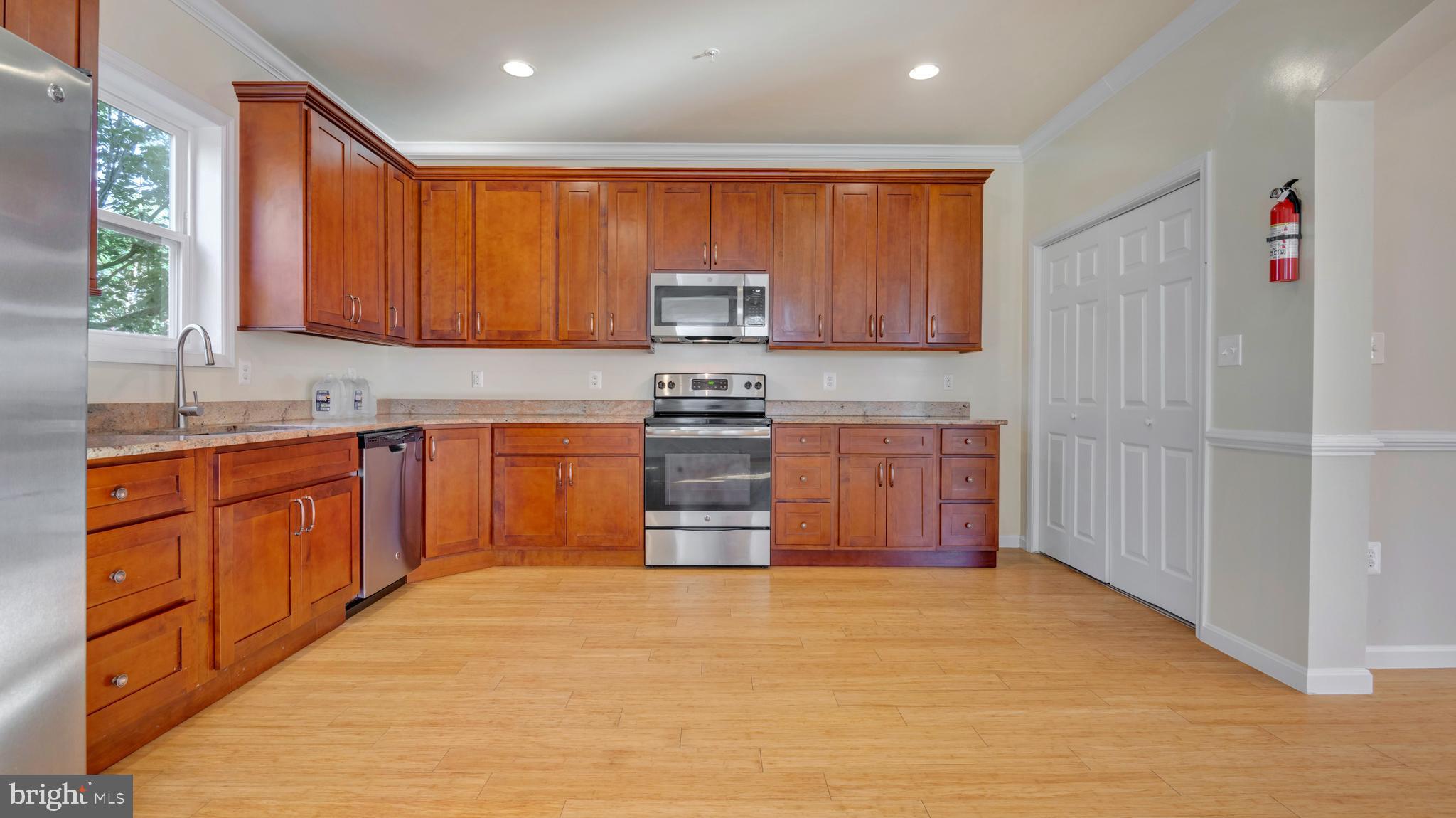 1337 Maple View Place Southeast Washington, DC 20020 - Photo 7 of 27 a kitchen with stainless steel appliances granite countertop a stove sink and cabinets