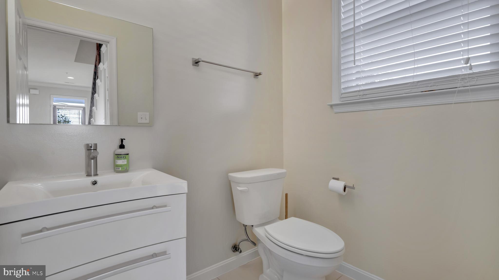 1337 Maple View Place Southeast Washington, DC 20020 - Photo 8 of 27 a bathroom with a sink a toilet and a mirror