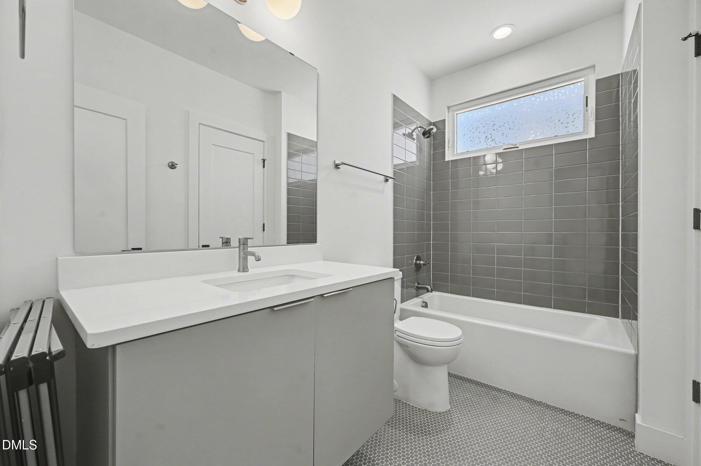 528 North Roxboro Street Durham, NC 27701 - Photo 14 of 26 a bathroom with a sink a toilet and shower