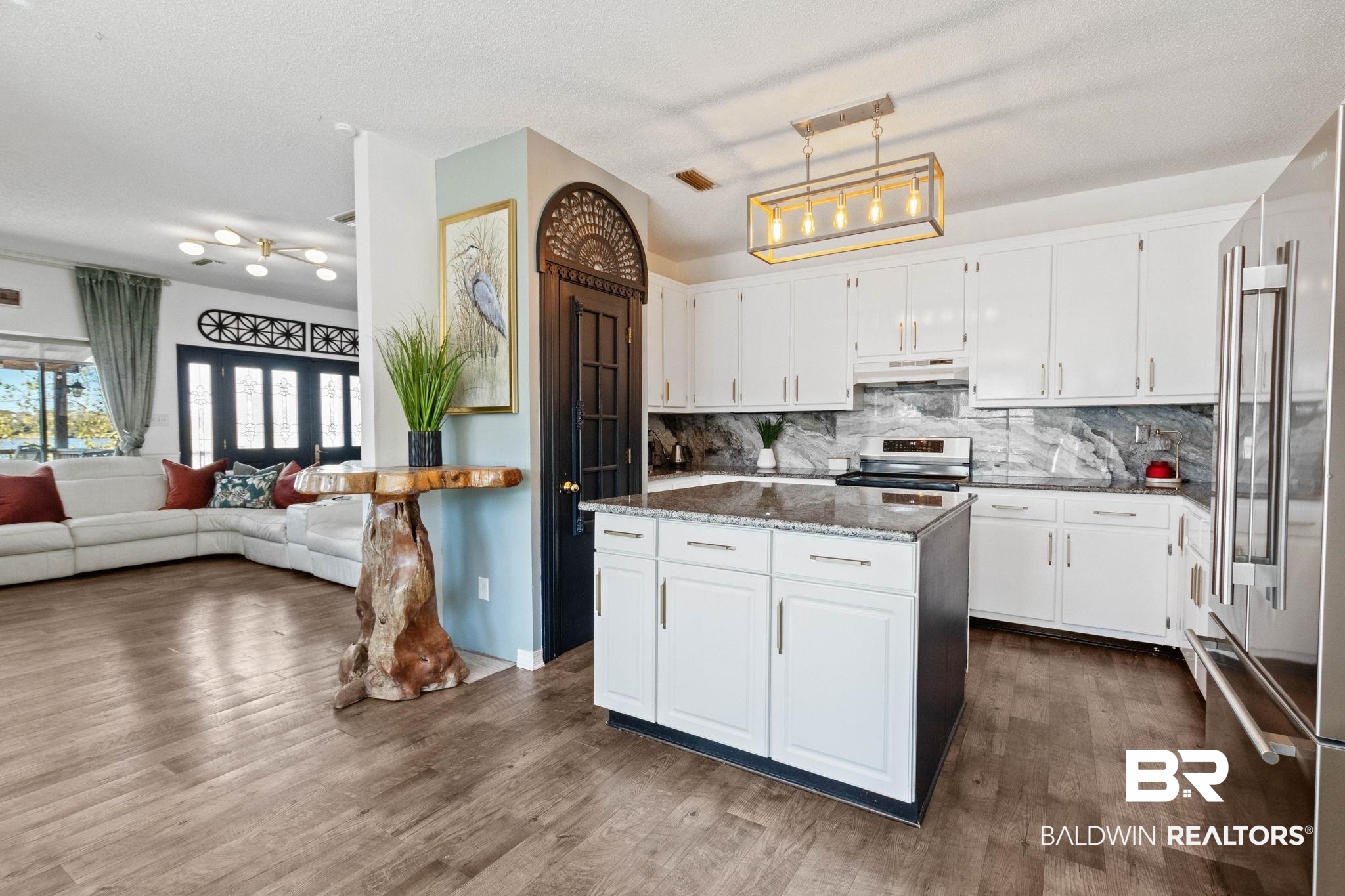 41997 Bayou Road Bay Minette, AL 36507 - Photo 3 of 68 Kitchen with white cabinetry, dark stone countertops, appliances with stainless steel finishes, a center island, and decorative backsplash
