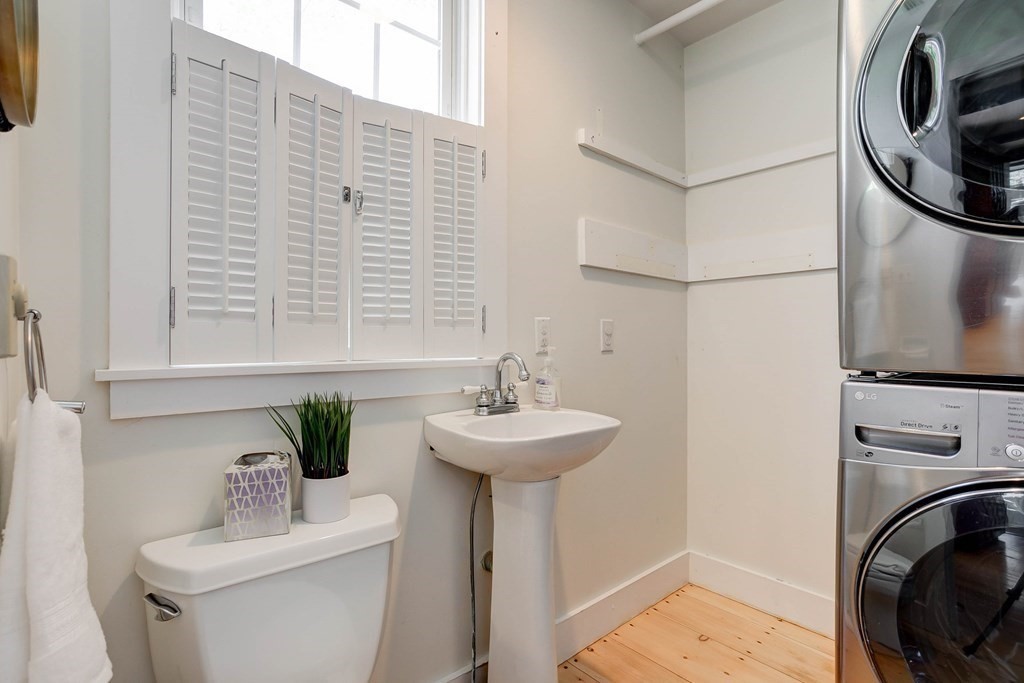 7 Lexington Road Concord, MA 01742 - Photo 11 of 42 a bathroom with a sink a washer and dryer