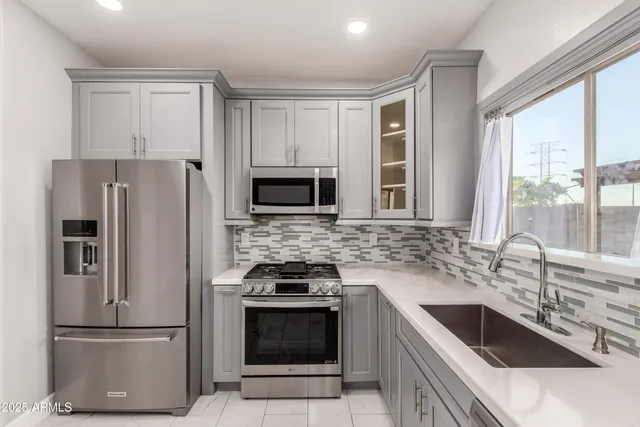 a kitchen with a sink stove and refrigerator