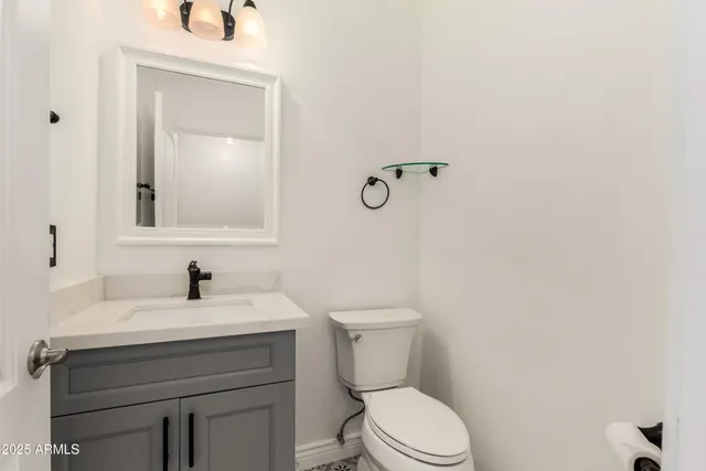 a bathroom with a sink toilet and mirror