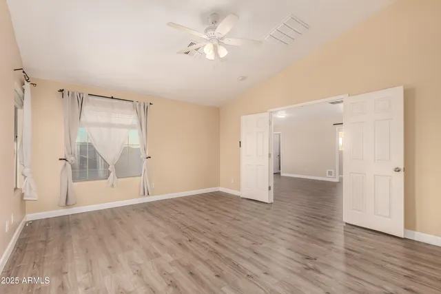 wooden floor in an empty room with a window