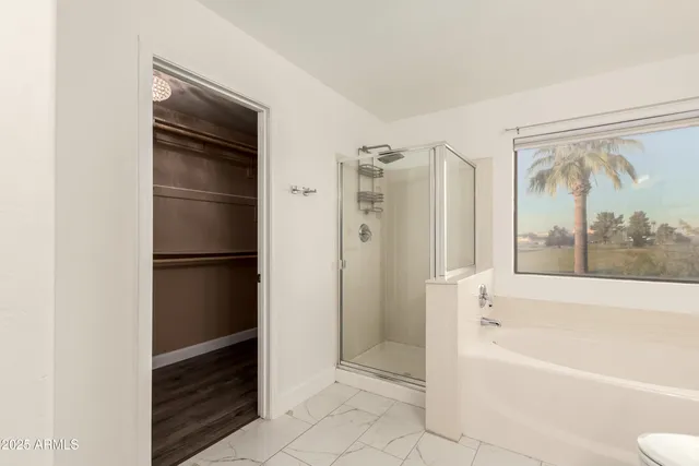 a bathroom with a bathtub and a shower