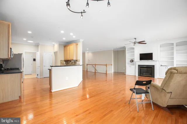 a living room with fireplace furniture and a wooden floor