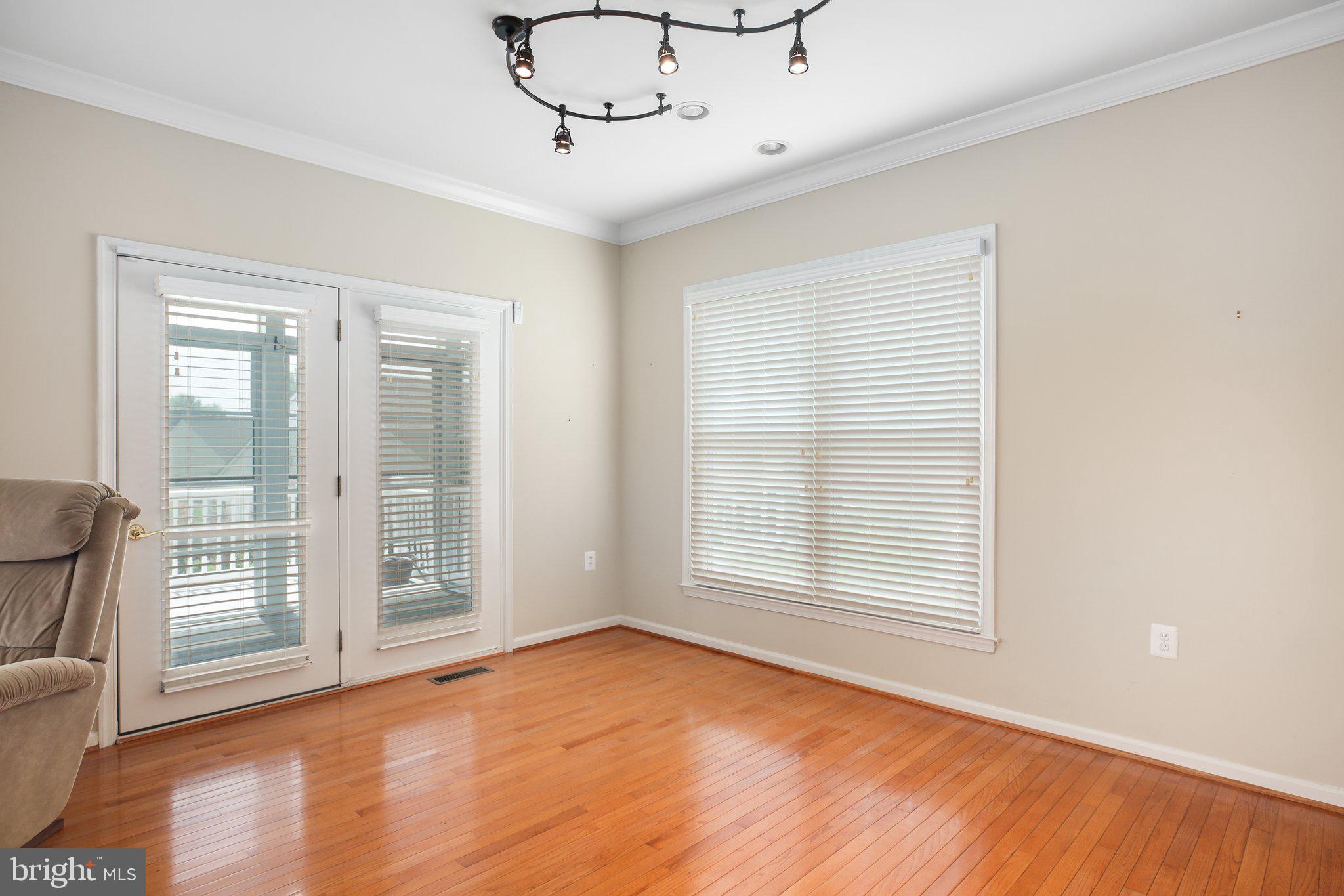 7 Carson Drive Fredericksburg, VA 22406 - Photo 18 of 51 a view of an empty room with a window and wooden floor
