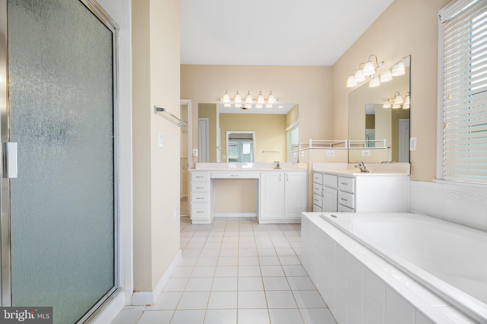 7 Carson Drive Fredericksburg, VA 22406 - Photo 27 of 51 a large white bathroom with a large mirror vanity and a shower