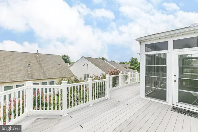 a view of balcony with wooden floor and fence