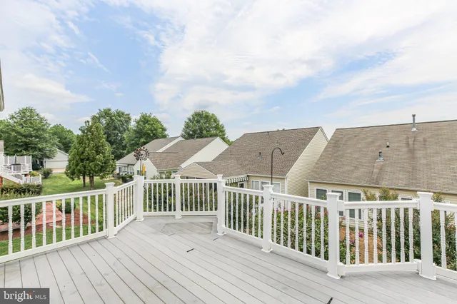 a view of a room with wooden floor and windows