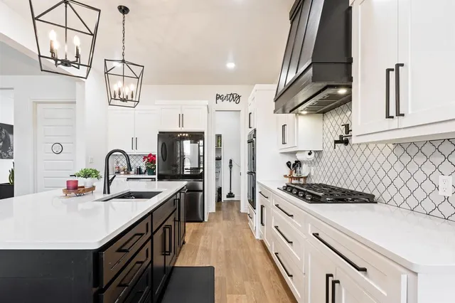 a kitchen with counter top space appliances and cabinets