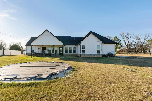 a front view of a house with a yard table and chairs