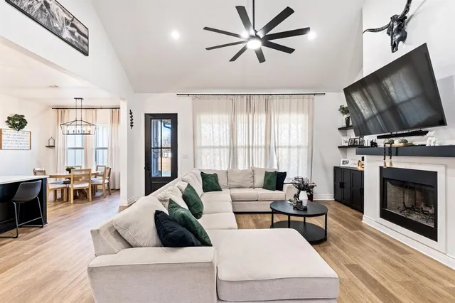 a living room with furniture and a view of kitchen