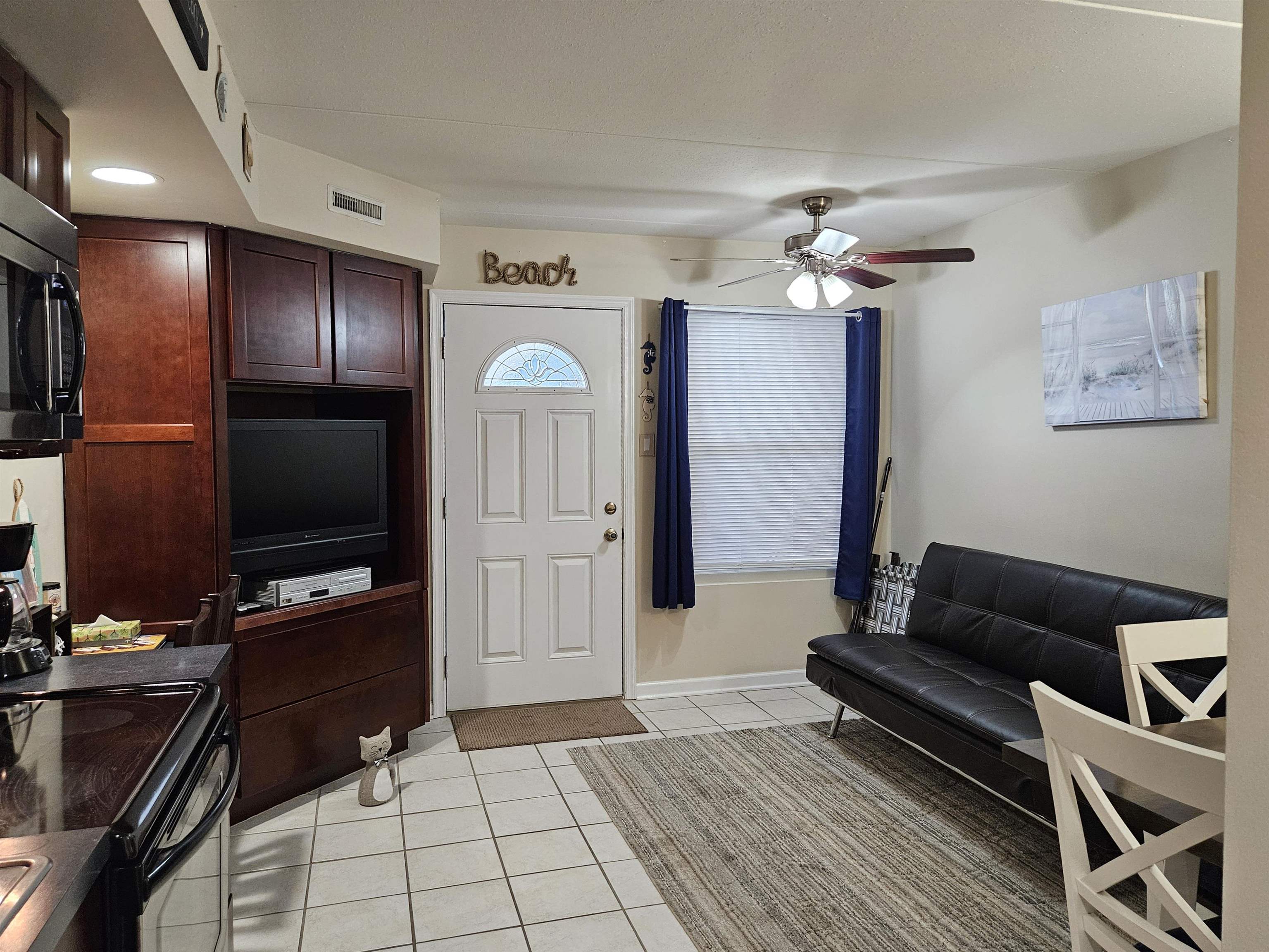 208 East Forget-Me-Not Road, Unit 111 Wildwood Crest, NJ 08260 - Photo 11 of 16 a living room with furniture and a flat screen tv