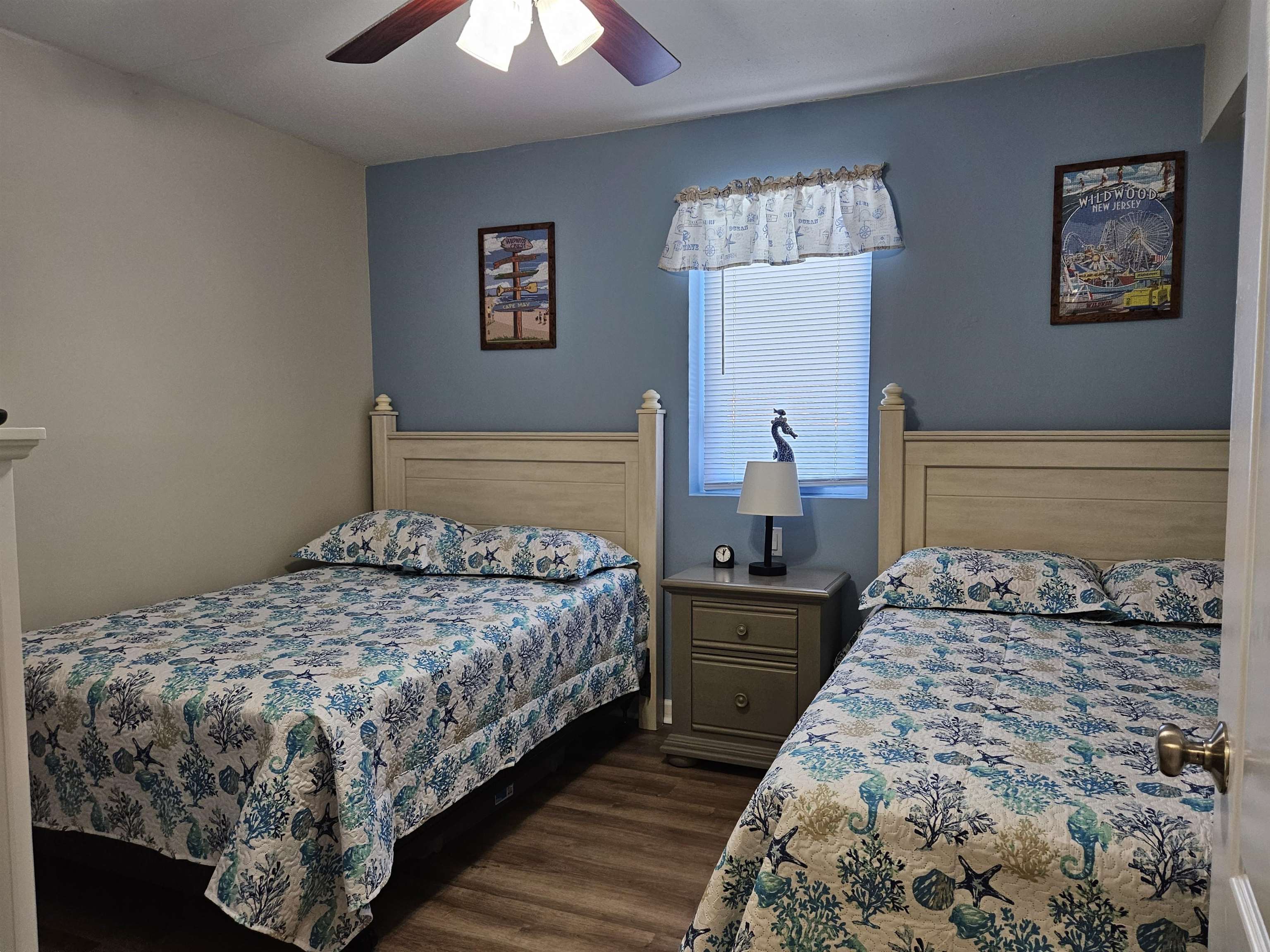 208 East Forget-Me-Not Road, Unit 111 Wildwood Crest, NJ 08260 - Photo 6 of 16 a bedroom with a bed and a chandelier