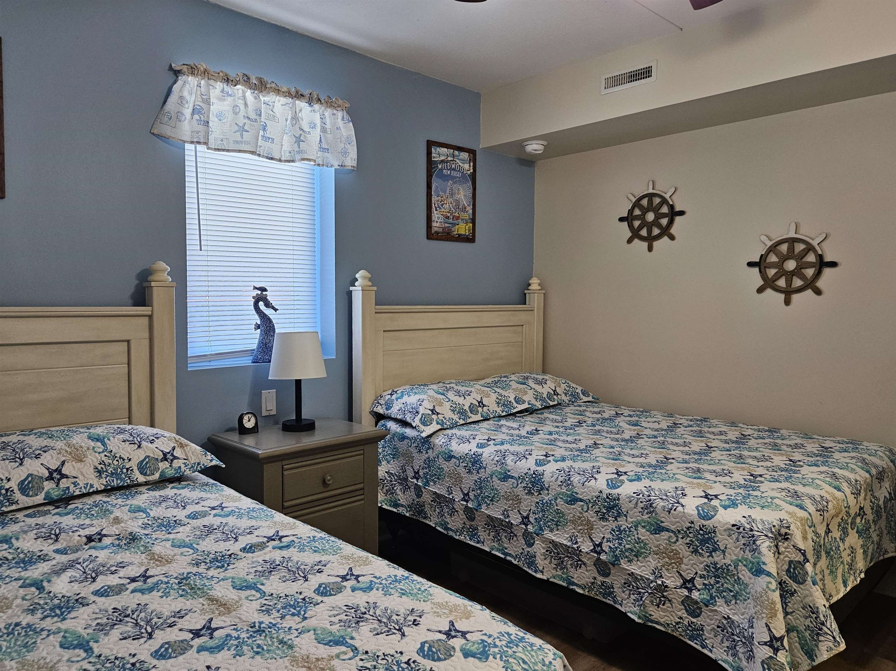 208 East Forget-Me-Not Road, Unit 111 Wildwood Crest, NJ 08260 - Photo 7 of 16 a bedroom with a large bed and a chandelier