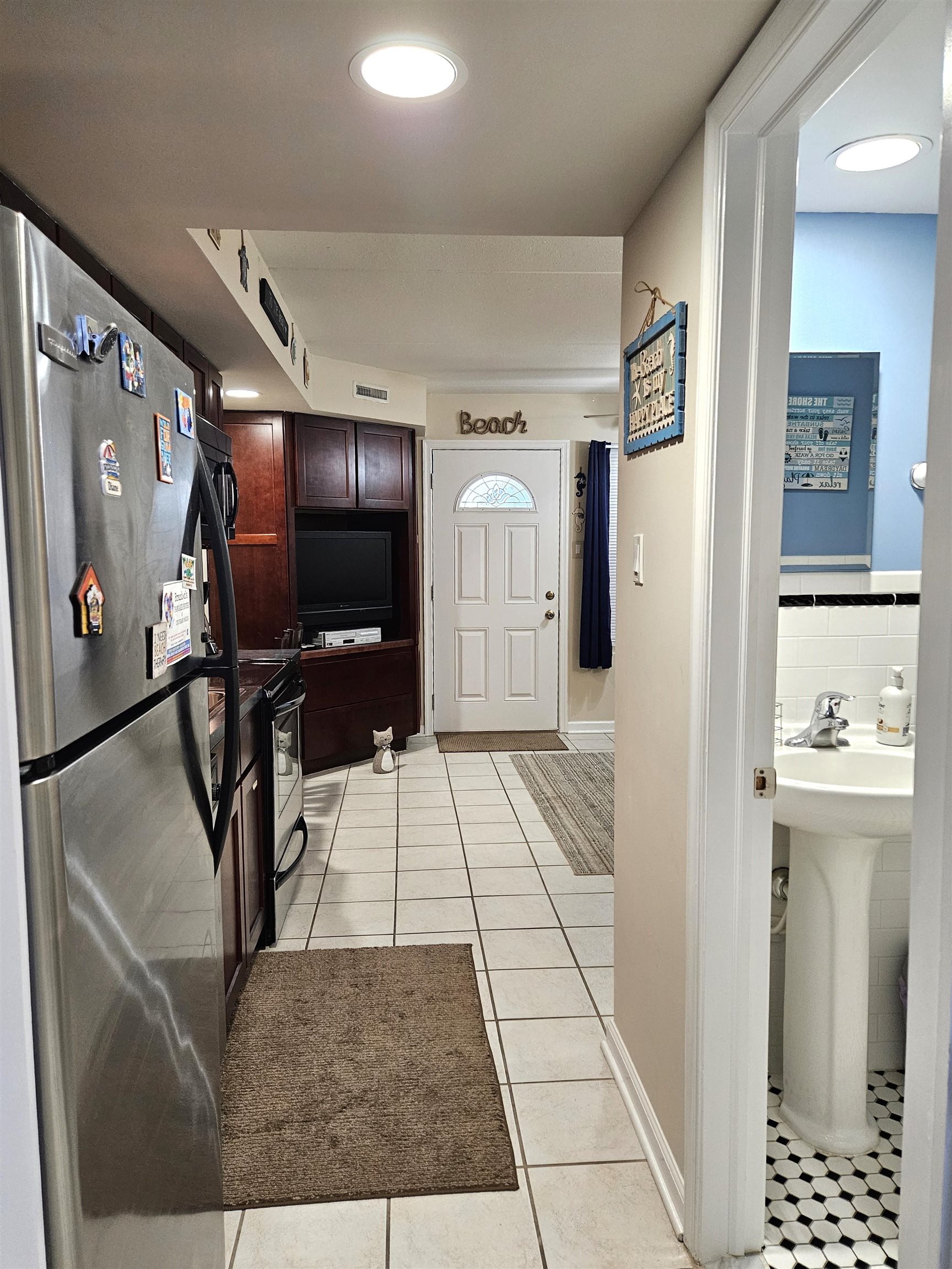 208 East Forget-Me-Not Road, Unit 111 Wildwood Crest, NJ 08260 - Photo 10 of 16 a view of a hallway with furniture and refrigerator
