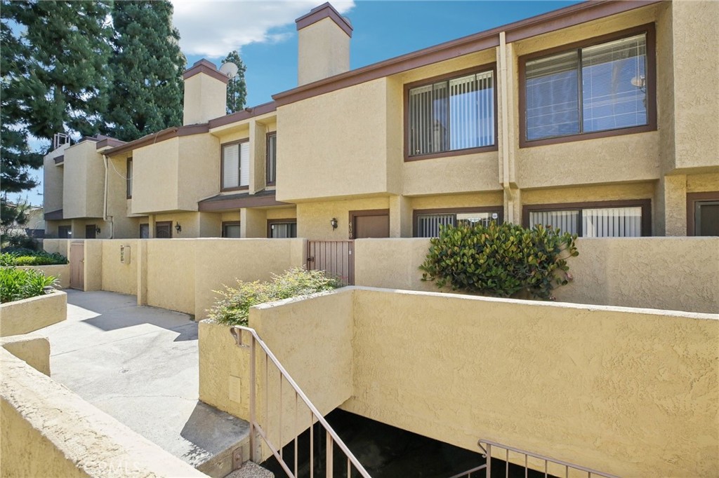 849 East Victoria Street, Unit 408 Carson, CA 90746 - Photo 1 of 1 a view of a patio with couches table and chairs and potted plants