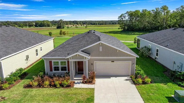 a aerial view of a house with garden and a yard