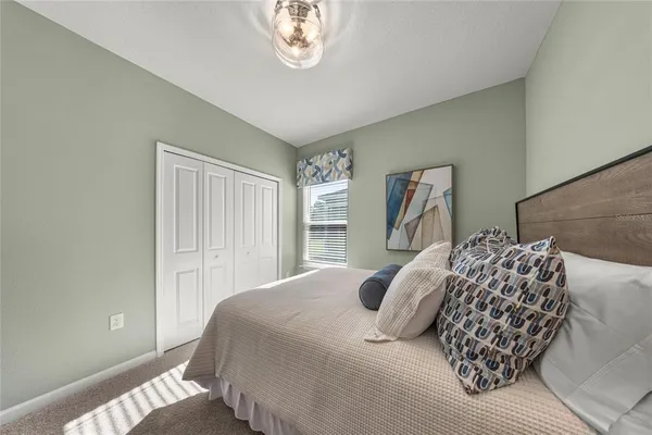 a bedroom with a large bed and a window