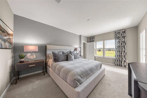 a bedroom with a bed and a couch