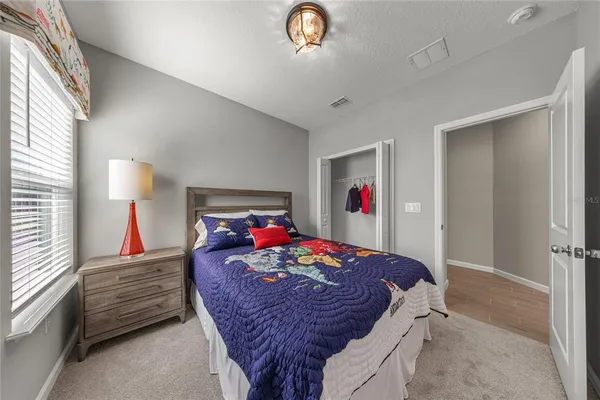 a bed room with furniture and a chandelier