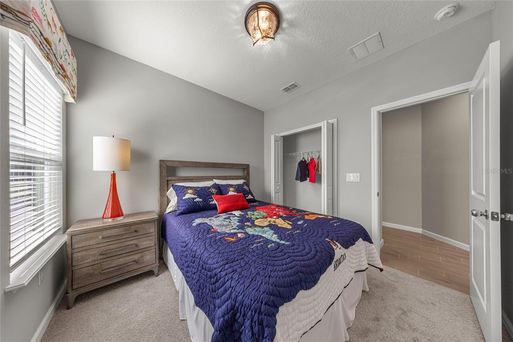 8904 Southwest 69th Terrace Ocala, FL 34476 - Photo 9 of 26 a bed room with furniture and a chandelier