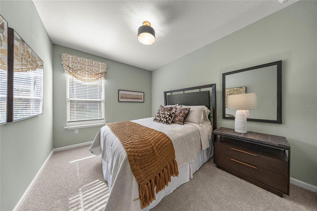 8904 Southwest 69th Terrace Ocala, FL 34476 - Photo 10 of 26 a bedroom with a bed and a large window