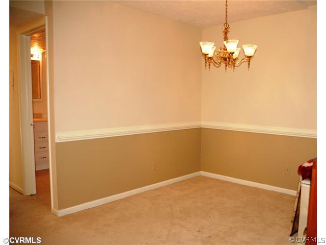 1505 Regency Woods Road, Unit 101 101 Henrico, VA 23238 - Photo 4 of 12 Dining Room - Formal dining room with chair rail moulding and chandelier
