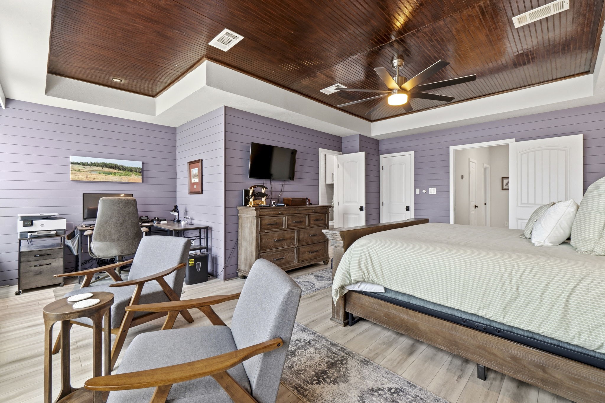2 Key Harbour Conroe, TX 77356 - Photo 28 of 41 a bedroom with a bed desk chair and a ceiling fan