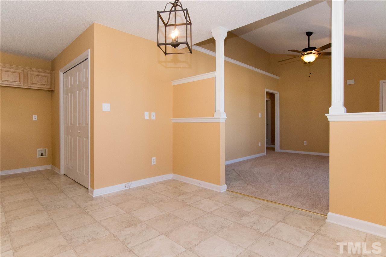 7112 Spanglers Spring Way Raleigh, NC 27610 - Photo 5 of 19 an empty room with kitchen view
