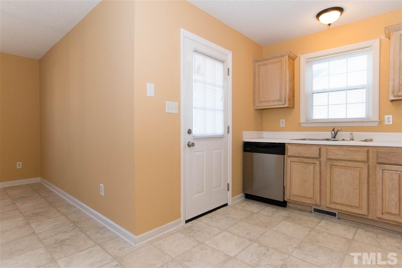 7112 Spanglers Spring Way Raleigh, NC 27610 - Photo 7 of 19 a view of a kitchen with white cabinets