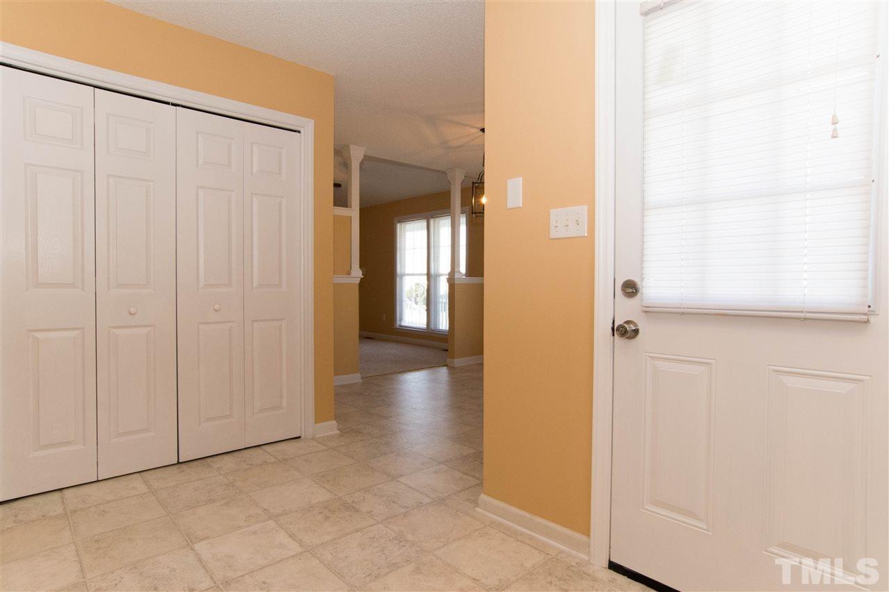 7112 Spanglers Spring Way Raleigh, NC 27610 - Photo 8 of 19 a view of a hallway with wooden floor