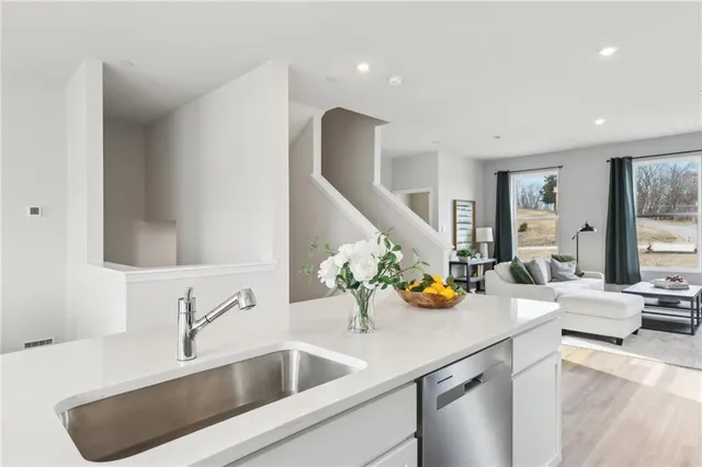 a kitchen with a sink and breakfast area