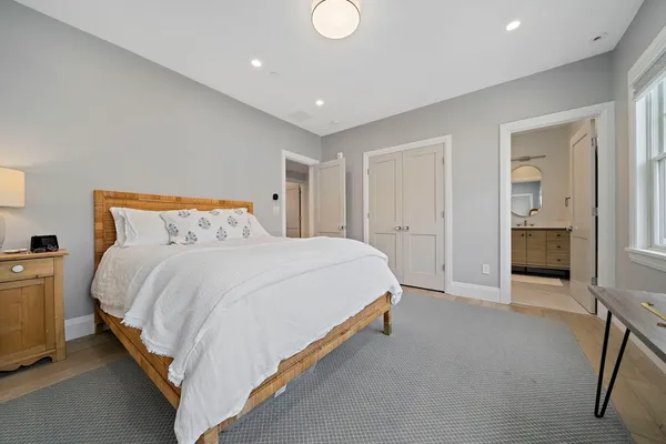 a spacious bedroom with a bed and a fireplace