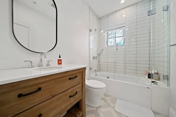 a bathroom with a sink a toilet and a mirror