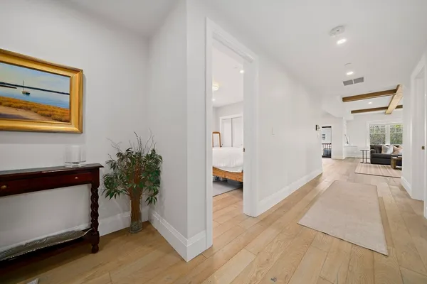 a view of hallway with furniture and a potted plant
