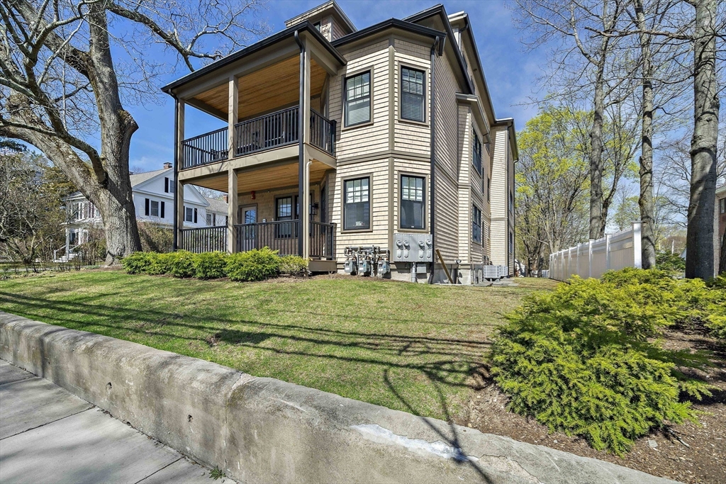 144 Linden Street, Unit 2 Wellesley, MA 02482 - Photo 20 of 28 front view of a house with a yard
