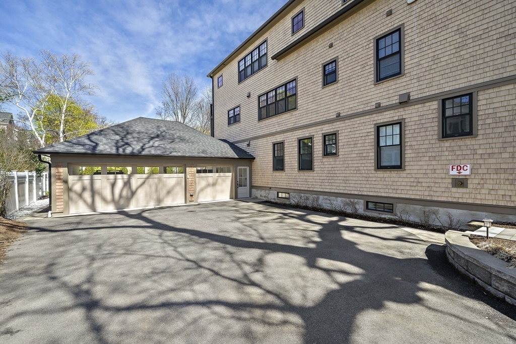 144 Linden Street, Unit 2 Wellesley, MA 02482 - Photo 23 of 28 a front view of a house with a yard
